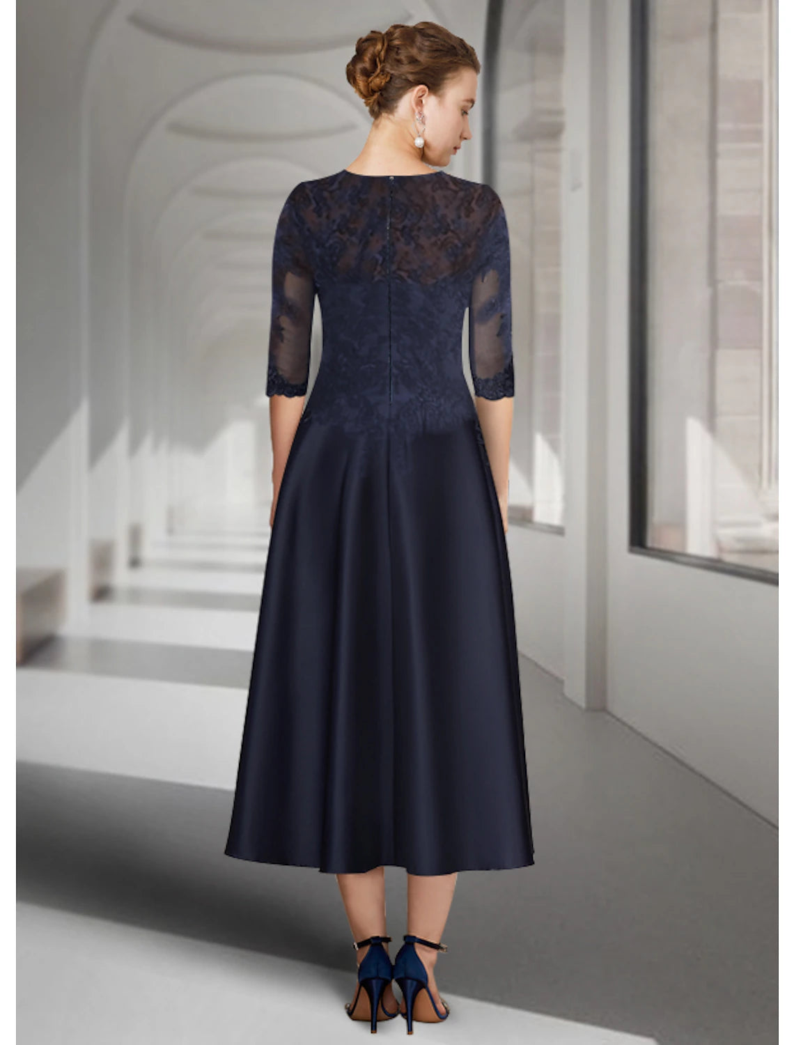 A-line tea-length satin mother of the bride dress featuring 3/4 length sleeves and pleated skirt