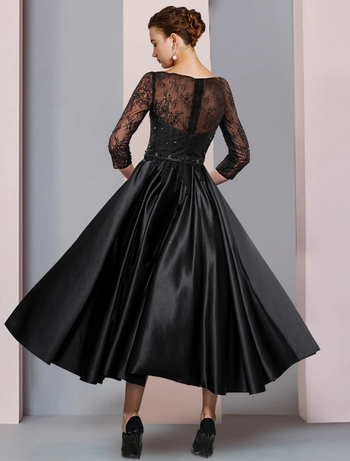 A-line tea-length mother of the bride dress featuring pleated satin and lace with waist sash