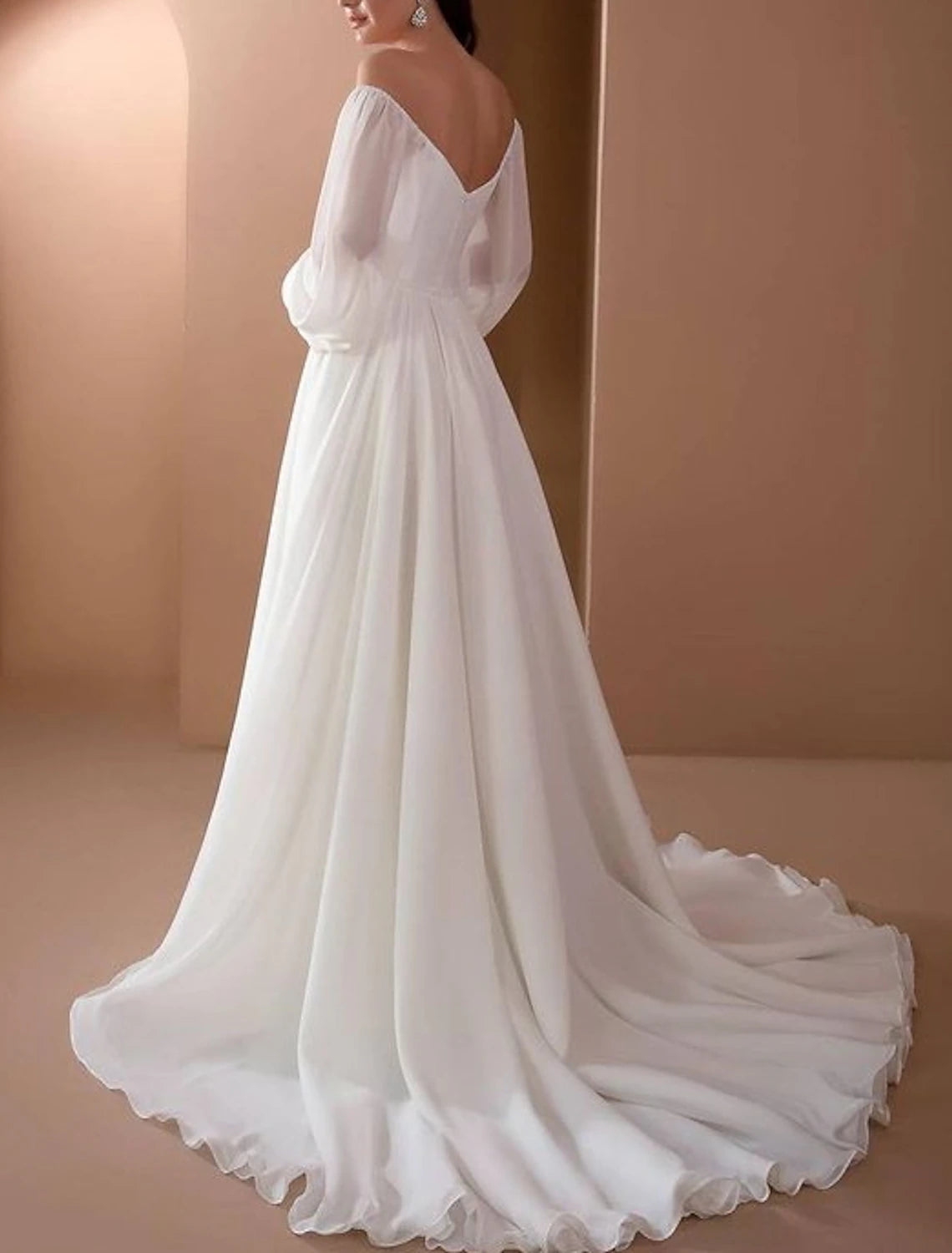 Vintage beach bridal gown featuring long sleeves, off-the-shoulder neckline, and court train