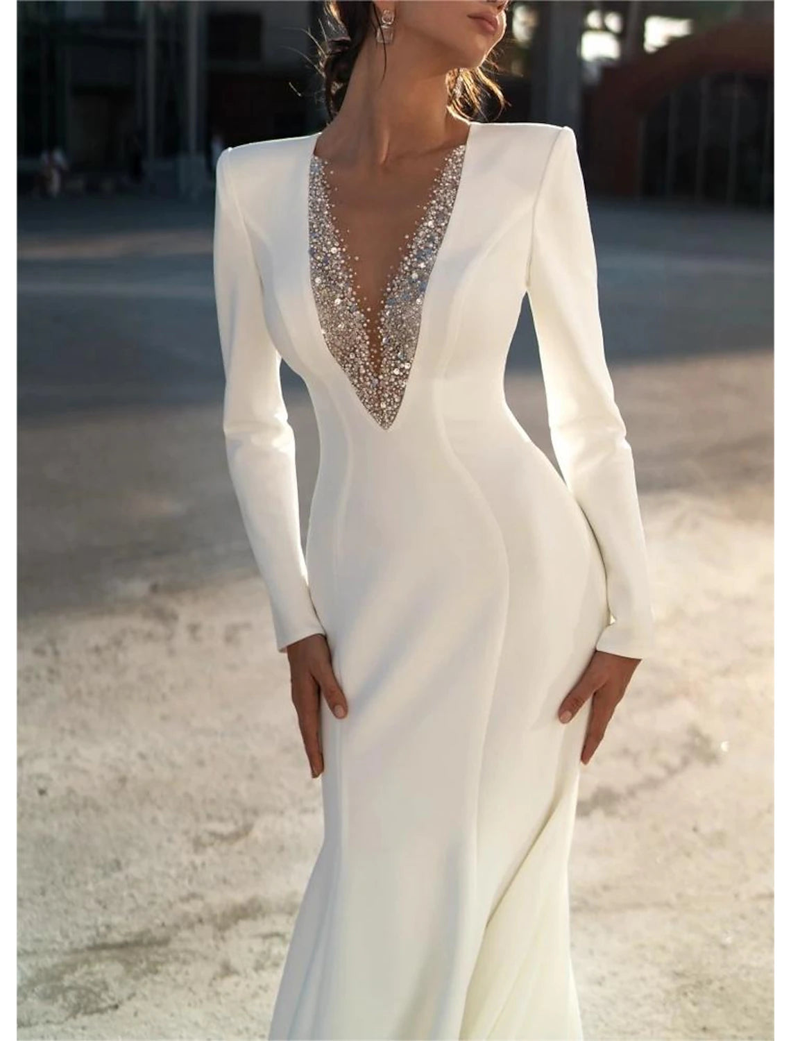 Chiffon mermaid wedding dress featuring sweep brush train and beaded accents