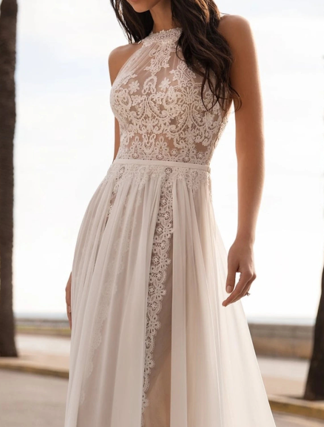 Halter neck sleeveless chiffon bridal gown with sweep brush train and embroidery