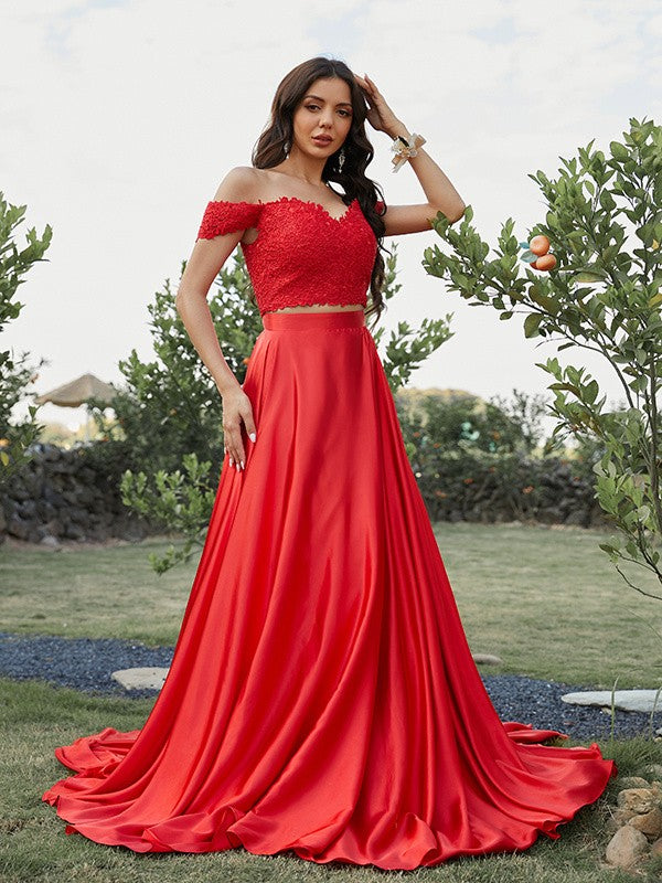 Close-up of applique details on two-piece off-the-shoulder silk-like satin prom dress