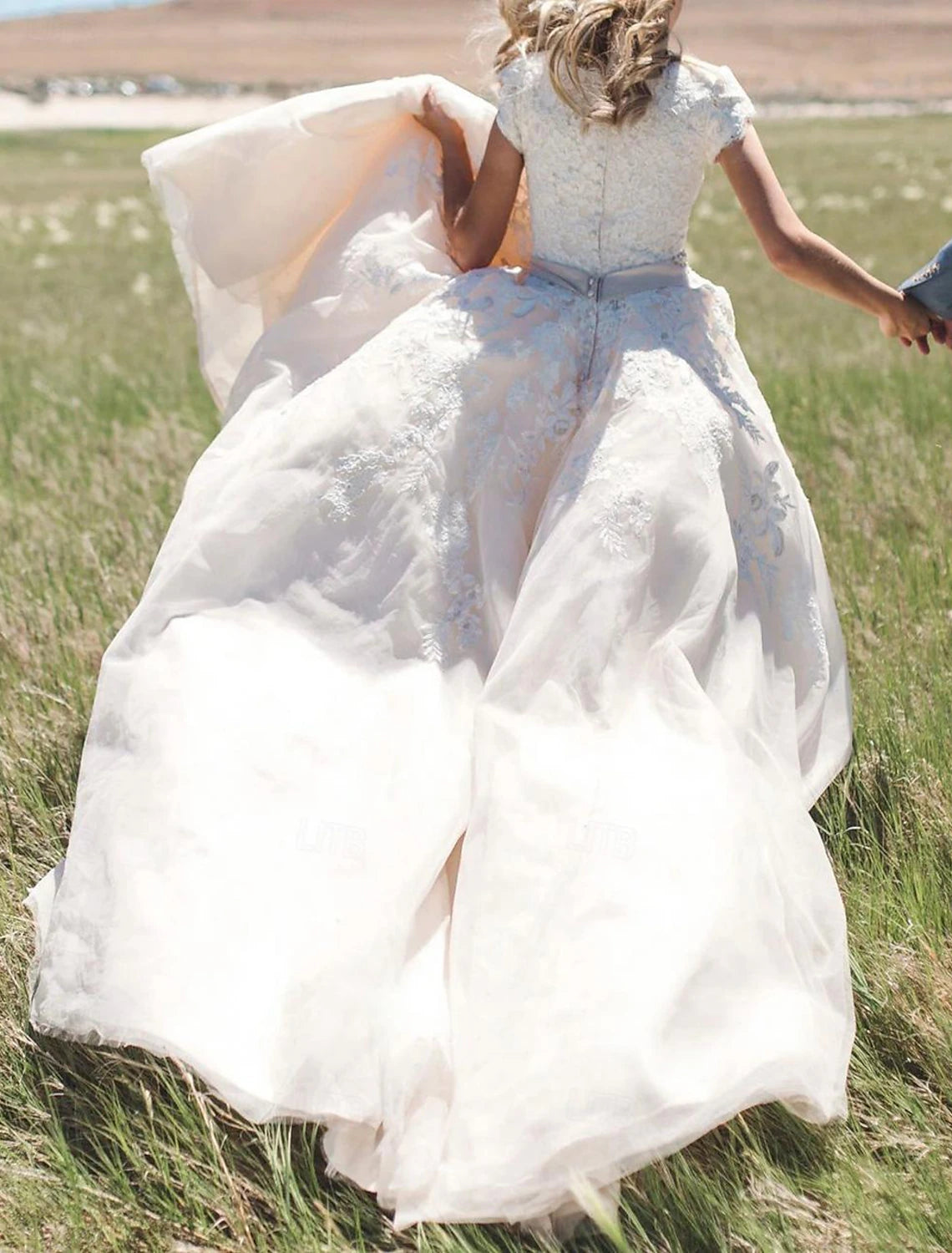 Chiffon bridal ball gown with cathedral train and applique details