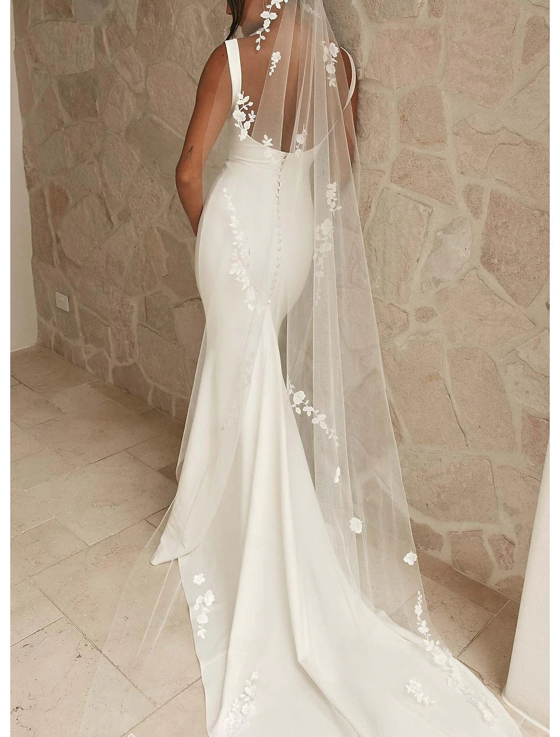 White camisole satin bridal gown featuring delicate beading and court train