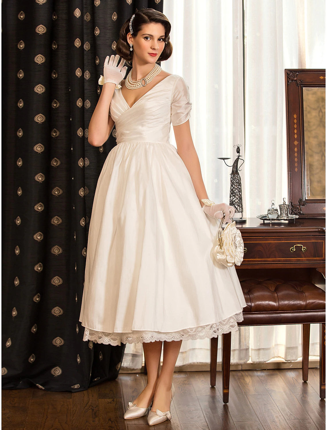 Ivory tea length satin wedding dress featuring V-neck and lace criss cross detailing