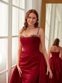 Sleeveless ruched satin prom gown with delicate spaghetti straps and chapel train