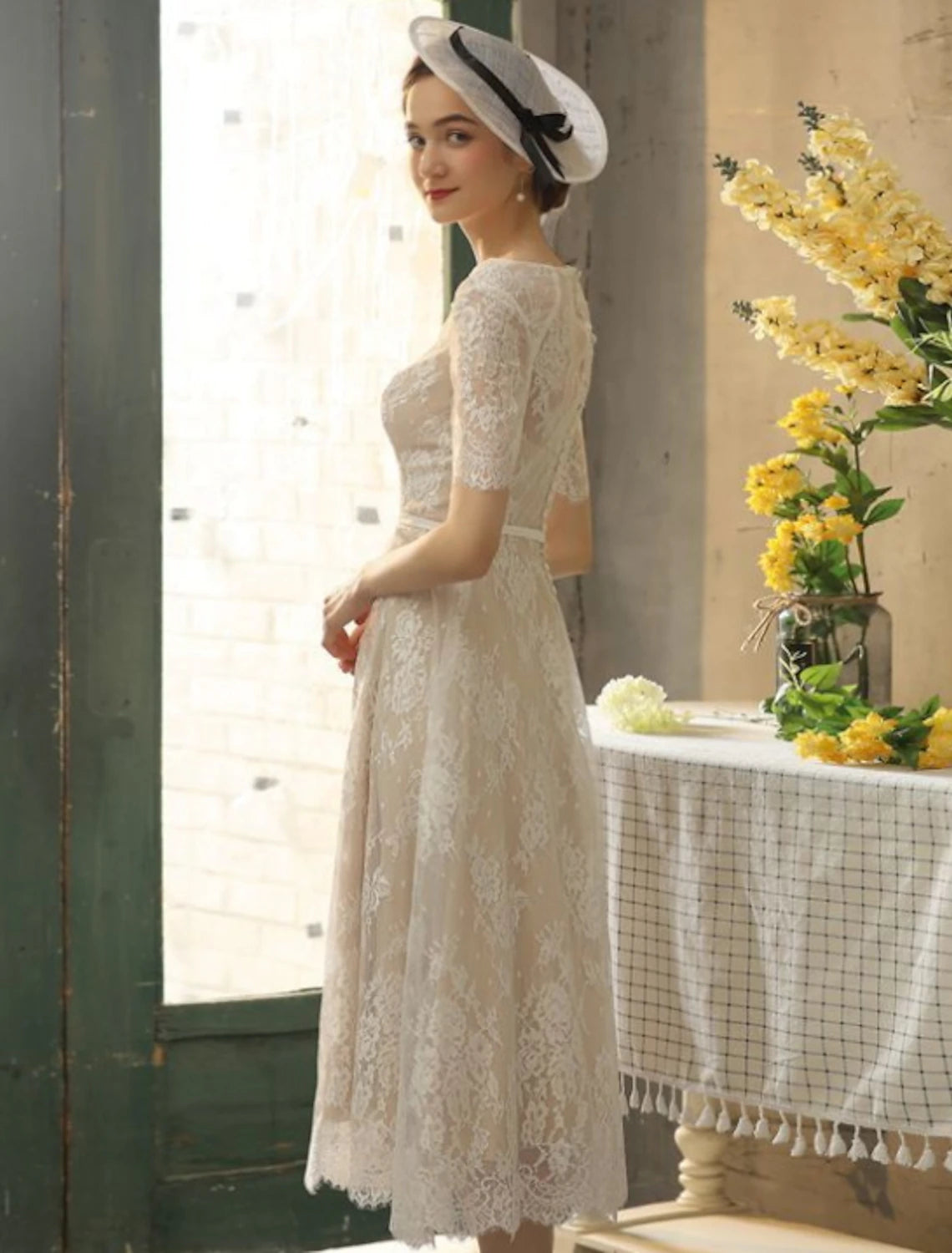 Champagne tea length wedding dress with illusion neck and lace detailing