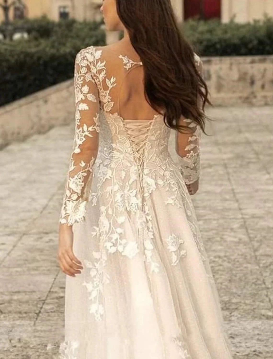 Bodice view of lace bridal gown showing V-neck and long sleeve detailing