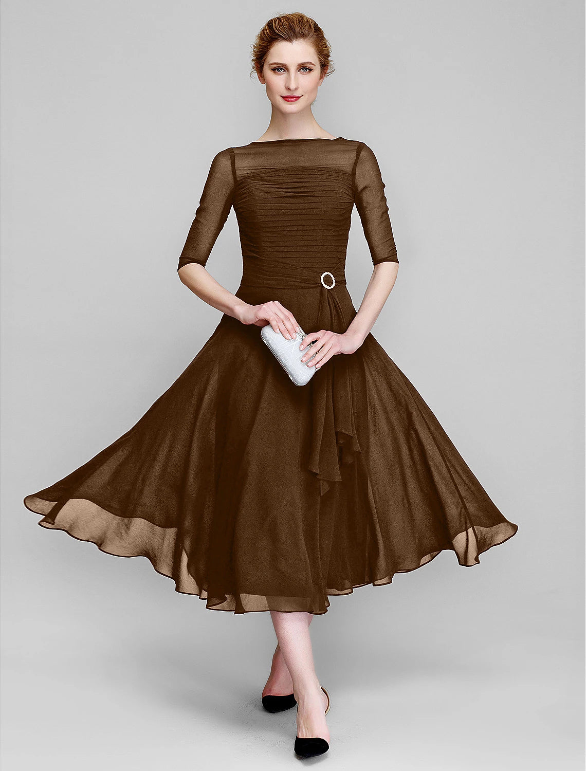 A-line mother of the bride gown crafted in tea length chiffon with ruched half sleeves