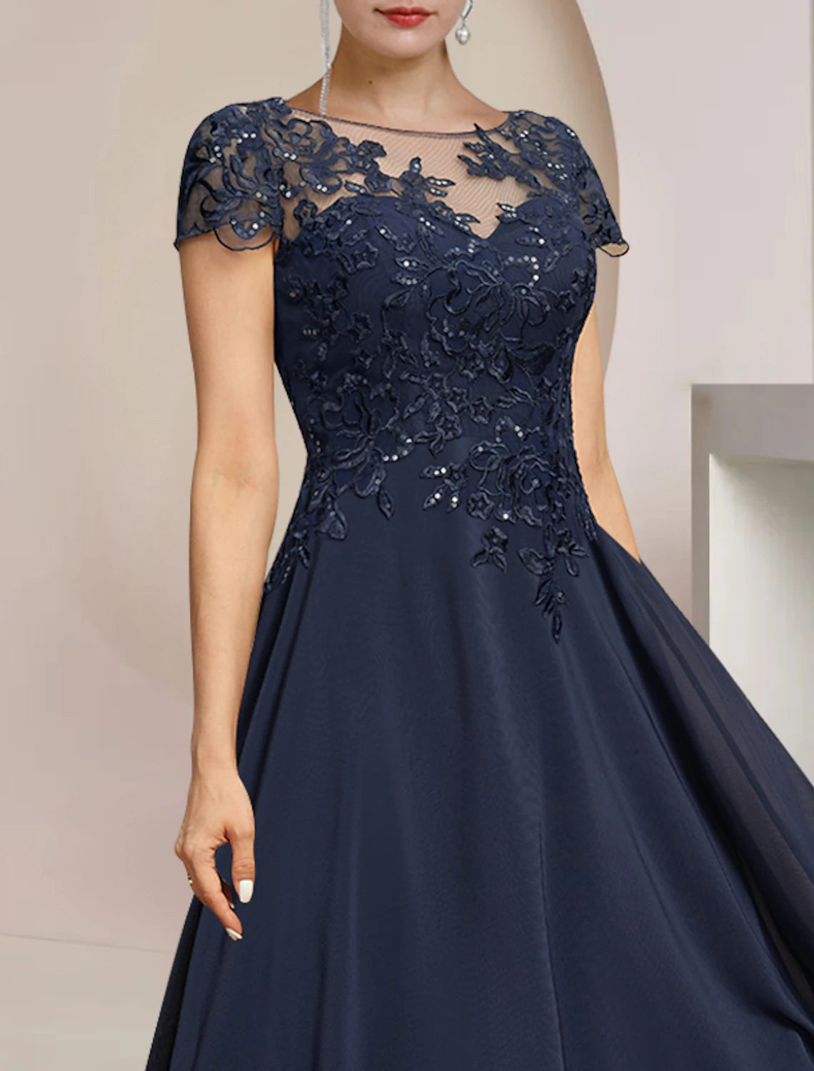 Asymmetrical tea length mother of the bride dress in dark navy chiffon and lace