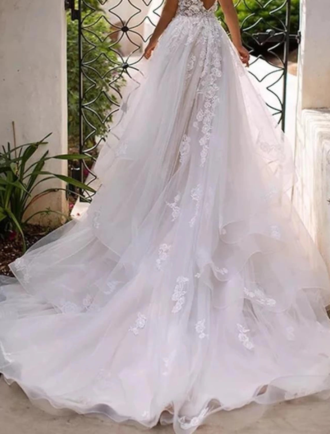 Close-up detail of lace appliques on ivory sweetheart beach wedding dress