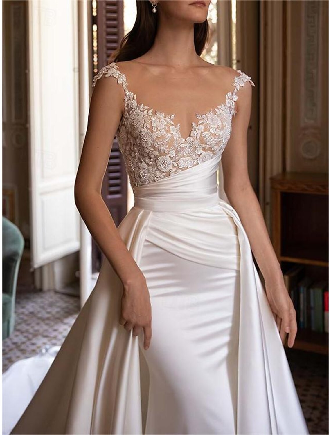 Sleeveless off-the-shoulder V-neck bodice with ruched pleats on satin wedding dress