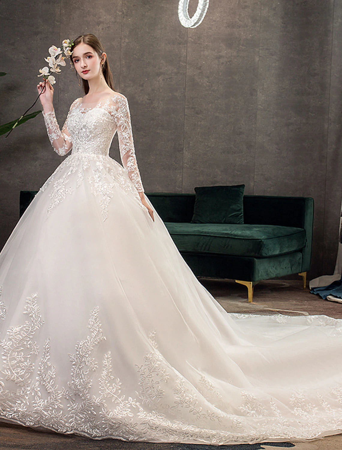 Lace bridal gown featuring long sleeves and cathedral train